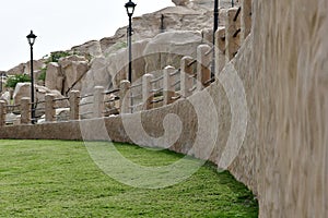 The entrance at ramp and green grass area at Al Qarah mountain resort area, at Land of civilization