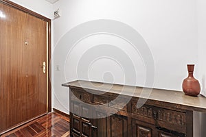 Entrance of a residential house with an old wooden sideboard