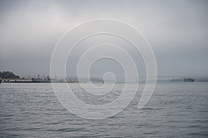 entrance of the seaport of San Francisco with a lot of fog and cloudy sky