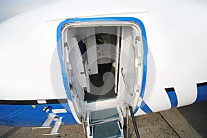 Entrance with stairs in big white-blue passenger airliner photo