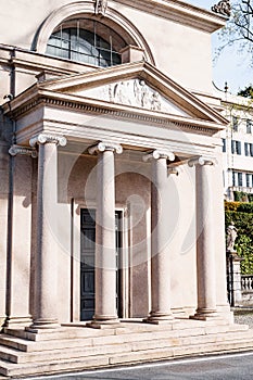Entrance stone colonnade with stairs in front of the building in classical style