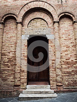 Entrance to an abbey with lateral columns and triple arch