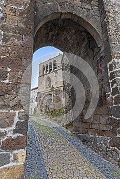 The entrance to Arlempdes medieval village, the paved walk pass guides to Saint-Pierre roman church, Haute-Loire in France