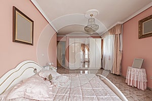 Entrance to a bedroom with a white lacquered wooden door, a wardrobe