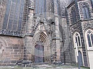 The entrance to the building of the Catholic Gothic cathedral, arches, crosses in the ornament.