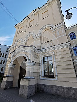 The entrance to the building of secondary school No. 1 in the historical part of the city of Vyborg against the blue sky