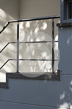 Entrance to building with tree light alone in the quarantine of the coronavirus with shadows cast on the tree wall