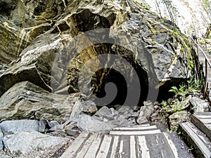 entrance to a cave in an old industrial excavation