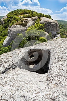 Entrance to the cave on top of a mountain. The sharp descent down the tunnel