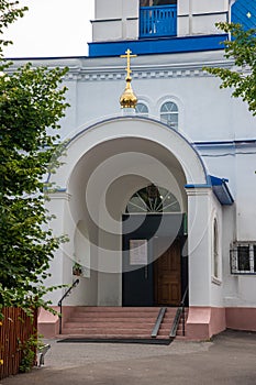 The entrance to the Christian Church is made of stone with Golden crosses.