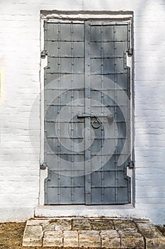 The entrance to the Church. The door covered with iron, closed and bolted with lock