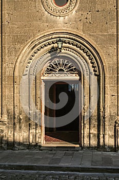 The entrance to the `Holy Sign` church in Gyumri is framed by oval stone patterned cornices.