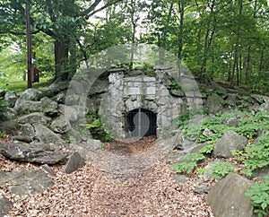 Entrance to coal mine with metal door and leaves