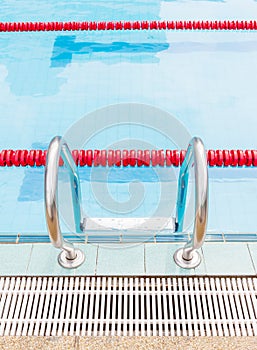 Entrance to competition swimming pool by metallic ladder.