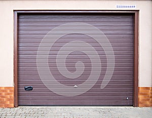 The entrance to the garage is equipped with a roller shutter gate.