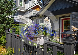 Entrance to a home through a beautiful garden with colorful flowers. Front of a house with Garden design
