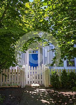 Entrance to a home through a beautiful garden with colorful flowers. Front of a house with Garden design