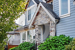 Entrance to a home through a beautiful garden with colorful flowers. Front of a house with Garden design