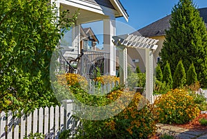 Entrance to a home through a beautiful garden with colorful flowers. Plants and flowers in in a garden
