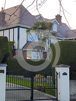 Entrance to a home through a beautiful garden with colorful flowers. Plants and flowers in pots on a doorstep leading to entrance