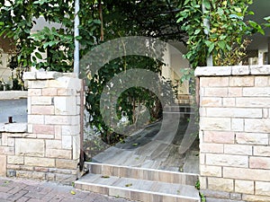 Entrance to the house, an arch overgrown with green ivy