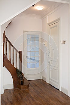 entrance to the house with the kitchen and living room doors and the stairs to the bedrooms