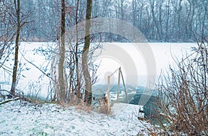 Entrance to the ice-hole on the winter river