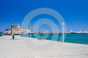 Entrance to Mandraki harbor and marina. Hirsch and Hirschkuh, Elafos and Elafina, bronze statues of deer and stags in the place of photo