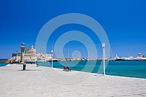 Entrance to Mandraki harbor and marina. Hirsch and Hirschkuh, Elafos and Elafina, bronze statues of deer and stags in the place of