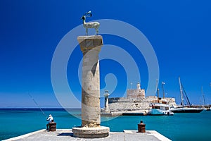 Entrance to Mandraki harbor and marina. Hirsch and Hirschkuh, Elafos and Elafina, bronze statues of deer and stags in the place of photo