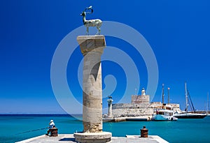 Entrance to Mandraki harbor and marina. Hirsch and Hirschkuh, Elafos and Elafina, bronze statues of deer and stags in the place of photo