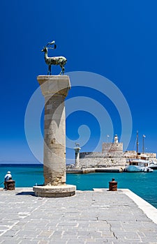 Entrance to Mandraki harbor and marina. Hirsch and Hirschkuh, Elafos and Elafina, bronze statues of deer and stags in the place of photo