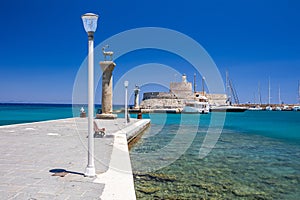 Entrance to Mandraki harbor and marina. Hirsch and Hirschkuh, Elafos and Elafina, bronze statues of deer and stags in the place of photo