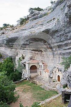 Entrance to National Monument Ojo Guarena, caves and church in the rock. Merindades, Burgos, Spain photo