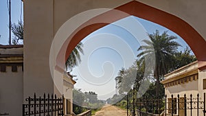 At the entrance to the park there is a metal lattice gate, an arched vault