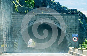 Entrance to the road tunnel that crosses the mountain wall. Photo taken from the car