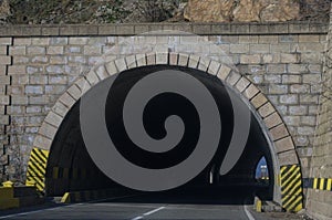 The entrance to a road tunnel that crosses the mountains.