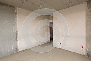 Entrance to the room in new building, plastered and concrete walls