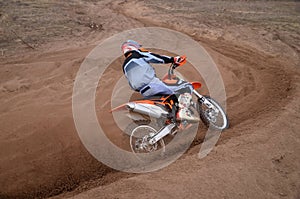 Entrance to turn the sandy track racer of motocross motorcycle w