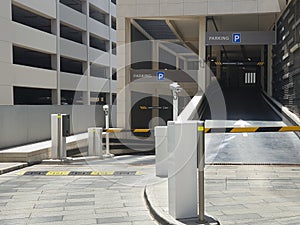 Entrance to underground, multi-storey Parking. Automatic barrier with video camera. Signpost parking. Pointer