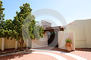 The entrance to villa and amphora with flowers at luxury hotel