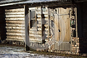 Entrance to the wooden house built of logs.