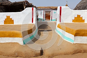 Entrance of traditionally painted house made with mud in a village of Khuri, Jaisalmer, India