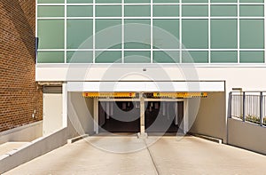 Entrance of underground parking lot in urban central street. Car park entrance passage