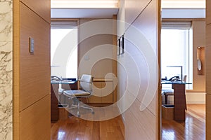 Entrance way to the living room with modern furnitures of a suite in a luxury hotel