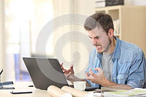 Entrepreneur angry and furious with laptop photo
