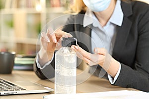 Entrepreneur applying hand sanitizer avoiding covid-19 at home photo