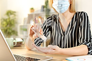 Entrepreneur hands with mask using sanitizer rub