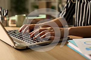 Entrepreneur hands working on laptop at night at home