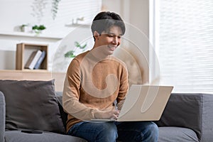 Entrepreneur handsome business asian man wear shirt sitting on couch working online with computer laptop smile happiness and relax